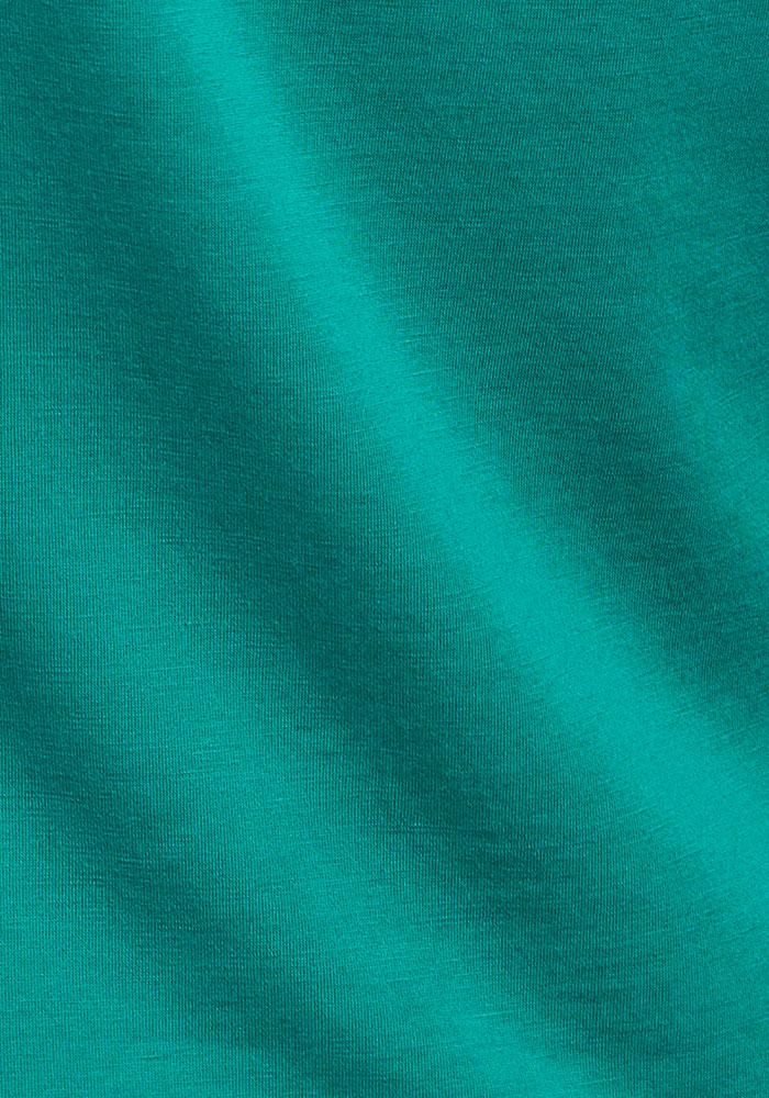 Close-up of Woolx Addie Crew Neck in Cabana Crush, showing ultra-soft teal fabric with textured diagonal folds.