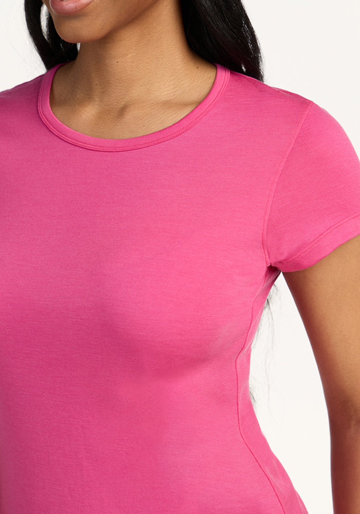 Woman wearing Woolx Addie Crew Neck in Raspberry Fizz, shown waist-up against a white background. Final Sale.