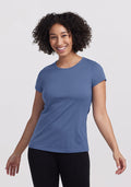 Smiling woman in Woolx Addie Crew Neck • Final Sale - Skyline, standing against a plain background in black pants.