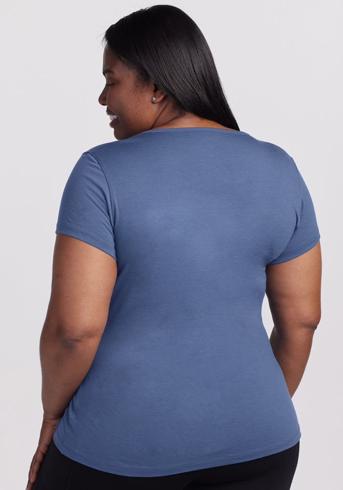 A woman with long dark hair models the Woolx Addie Crew Neck in Skyline, standing with her back to the camera.