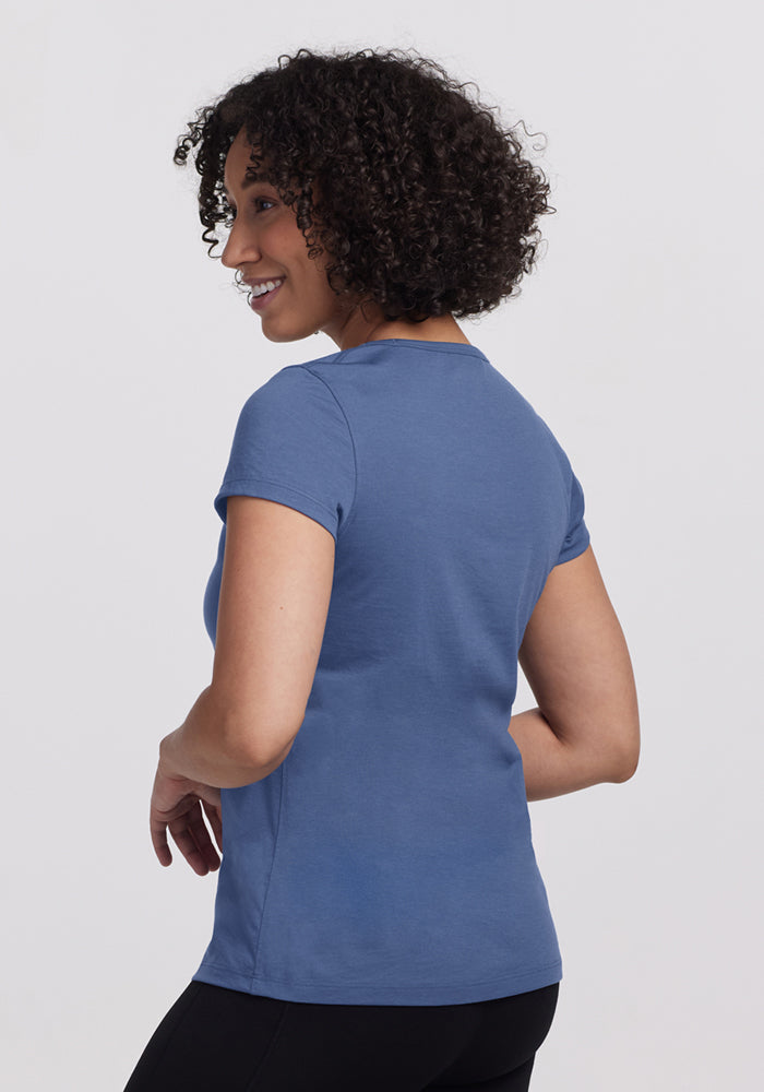 Smiling woman in Woolx Addie Crew Neck • Final Sale - Skyline, looking over her shoulder.