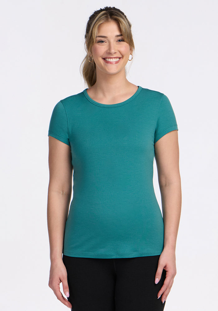 Blonde woman in ponytail smiles at camera wearing Woolx Addie Crew Neck • Final Sale - Surfside and black pants.