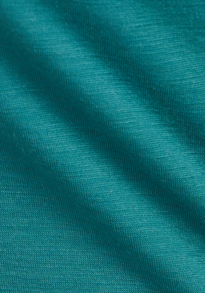 Close-up of Woolx Addie Crew Neck in Surfside, showing teal wool texture and soft folds. Final Sale.