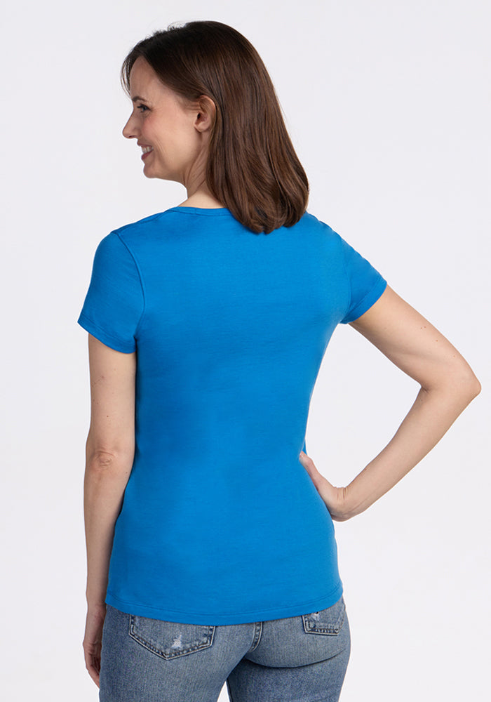 Woman wearing Woolx Addie Crew Neck in Wave Rider with jeans, standing against a plain background.