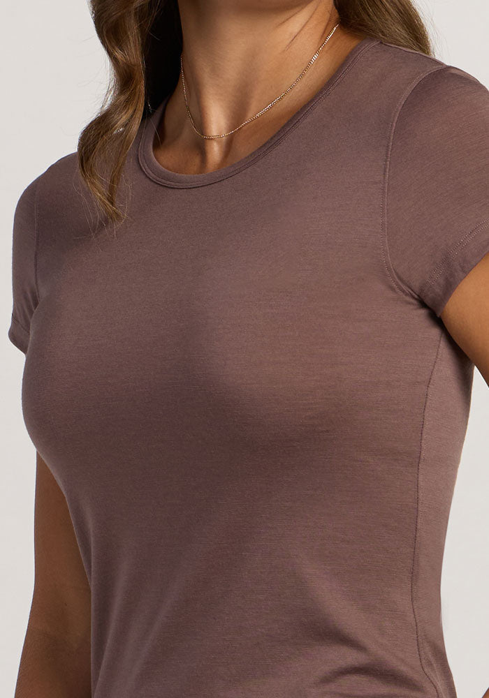 A woman wearing the Woolx Addie Crew Neck in Peppercorn and a thin gold necklace.