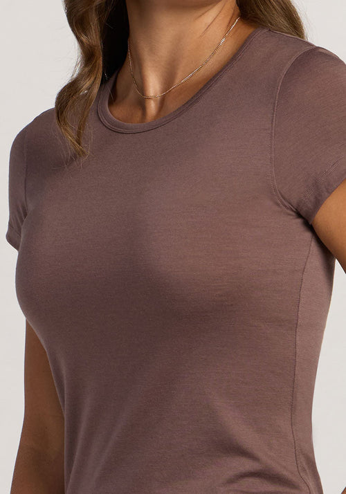 A woman wearing the Woolx Addie Crew Neck in Peppercorn and a thin gold necklace.