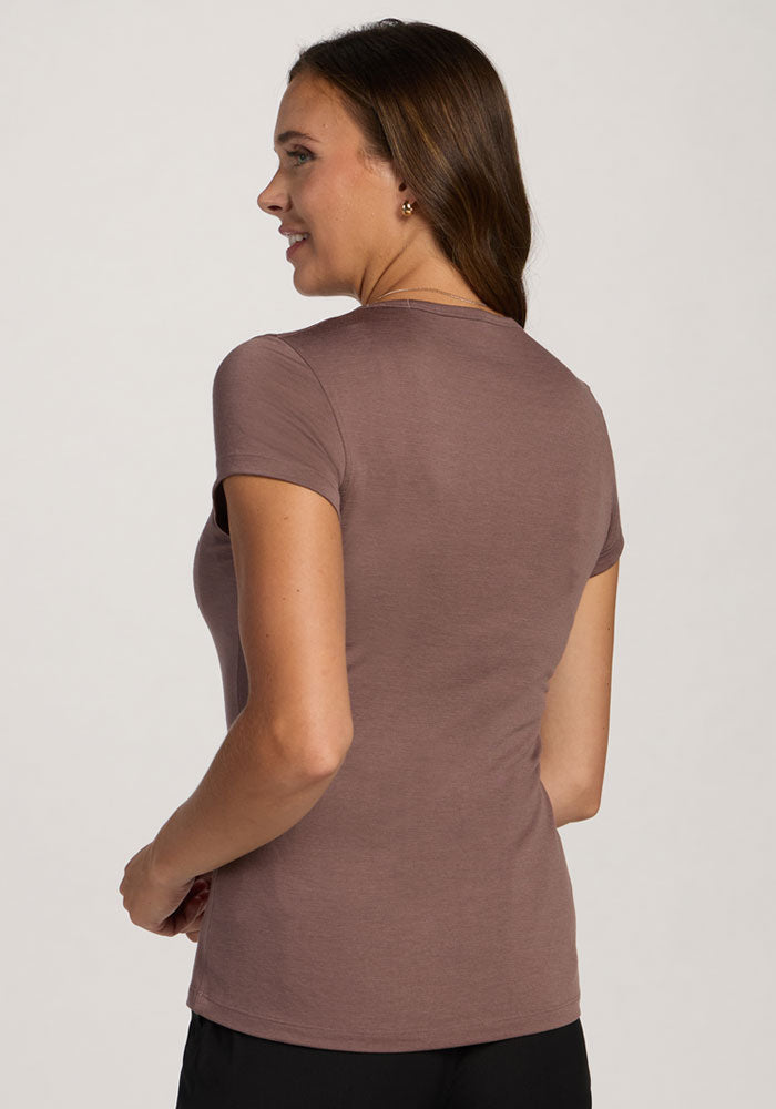 Woman with long brown hair wears the Woolx Addie Crew Neck in Peppercorn, standing and facing away from the camera.