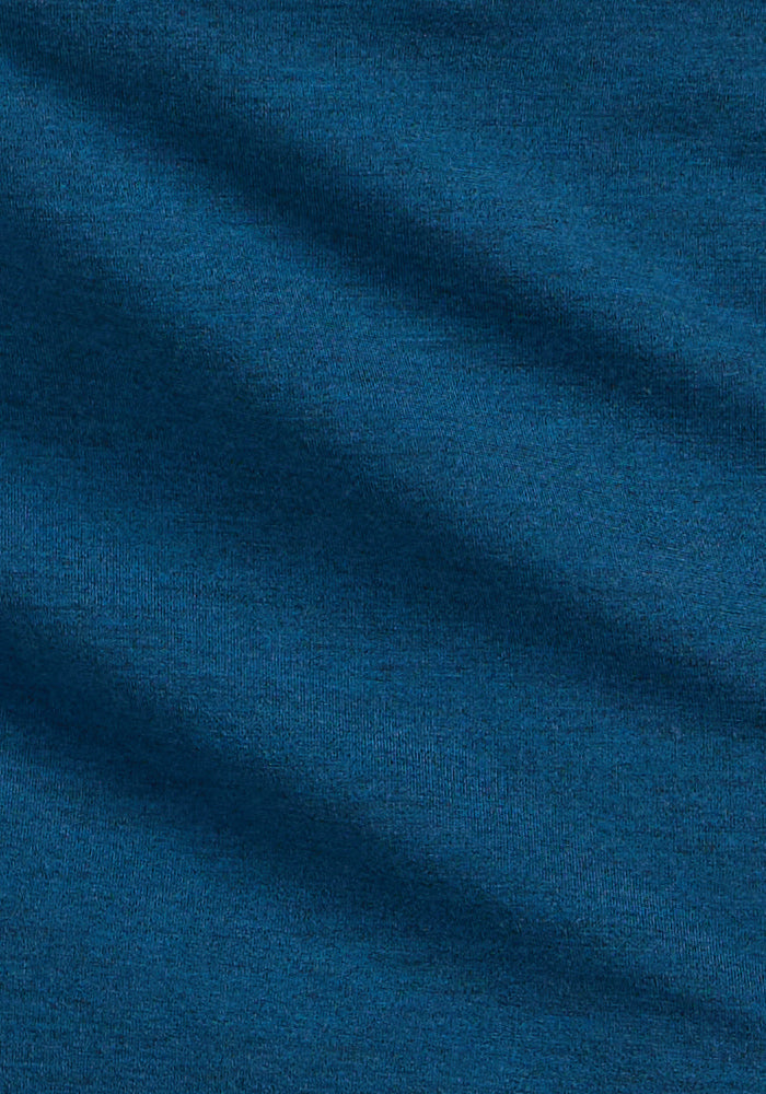 Close-up of Woolx Adrienne Active Dress in Majolica Blue, showing its soft fabric and gentle diagonal wave-like texture.