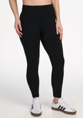 The image shows a person’s lower torso and legs against a white background, wearing Woolx Angela Leggings - Black and white Adidas sneakers with black stripes. | Ariana is 5'11", wearing a size S