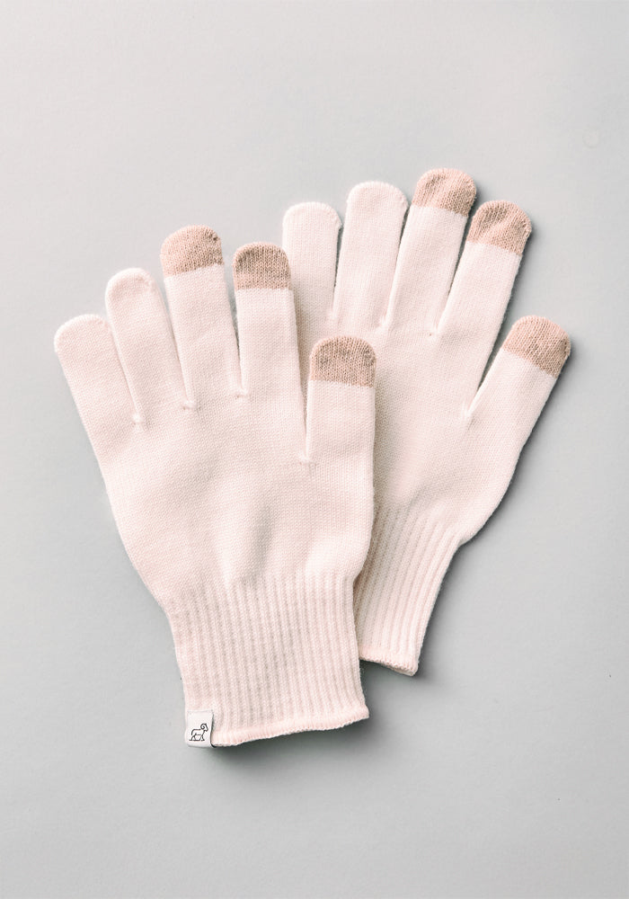 A pair of Woolx Asher Tech Gloves in Almost Mauve Merino wool, with light brown touchscreen tips on thumb, index, and middle fingers, laid flat on a light gray background.