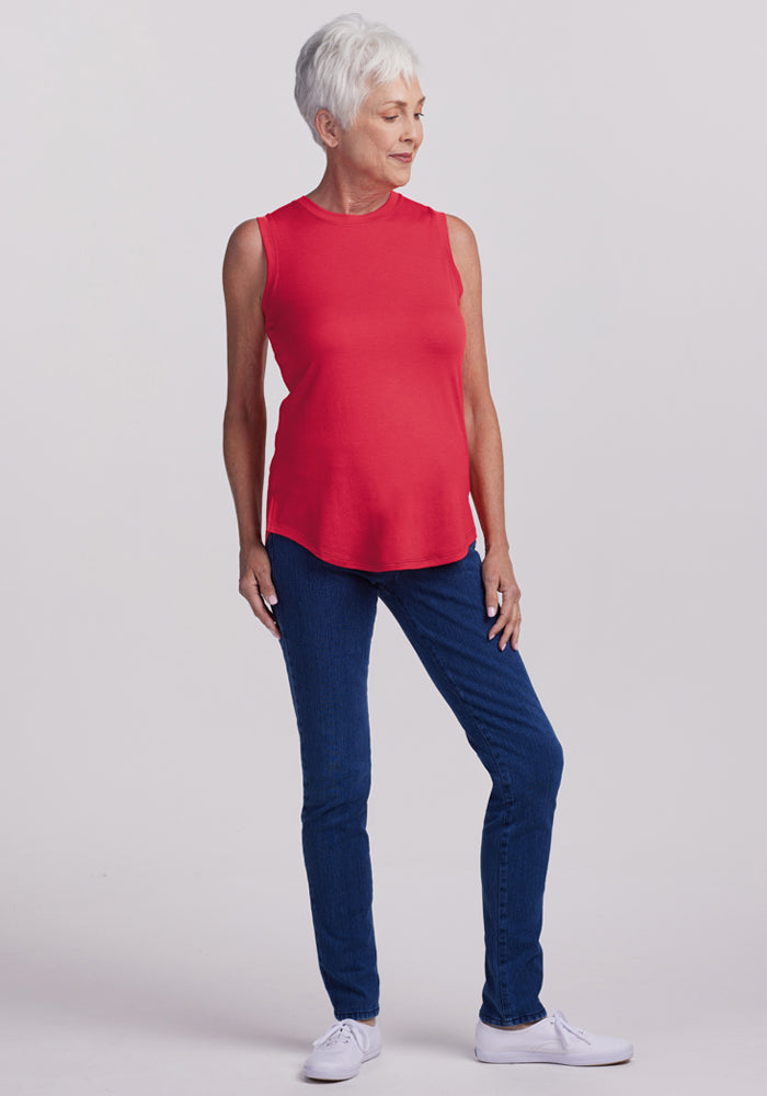 Older woman with short white hair wears the Woolx Bella Tunic Top in Berry Ice Pop, blue jeans, and white sneakers.