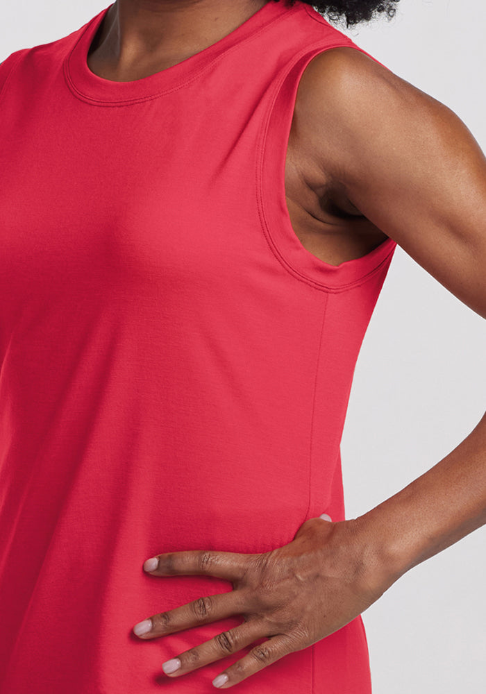 Woman wearing the Woolx Bella Tunic Top in Berry Ice Pop, shown shoulder to mid-torso with hand on her hip.