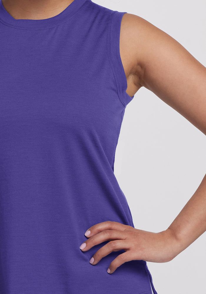 Person wearing a Woolx Bella Tunic Top in Berry Indigo, hand on hip, showing part of torso and arm.
