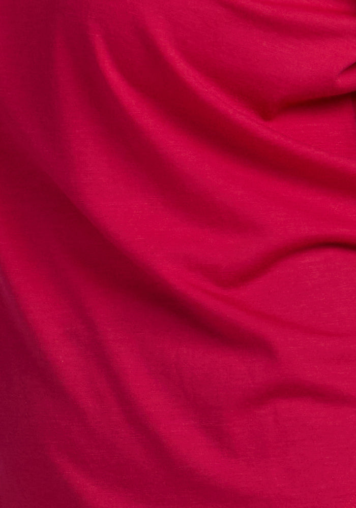 A close-up of the Woolx Bella Tunic Top in Poppy Spark, showing its lightweight merino folds and soft texture.