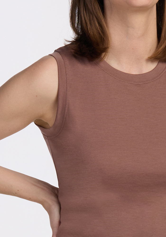 Woman models the Woolx Bella Tunic Top in Sienna Kiss, hand on hip; photo cropped at mouth and torso.