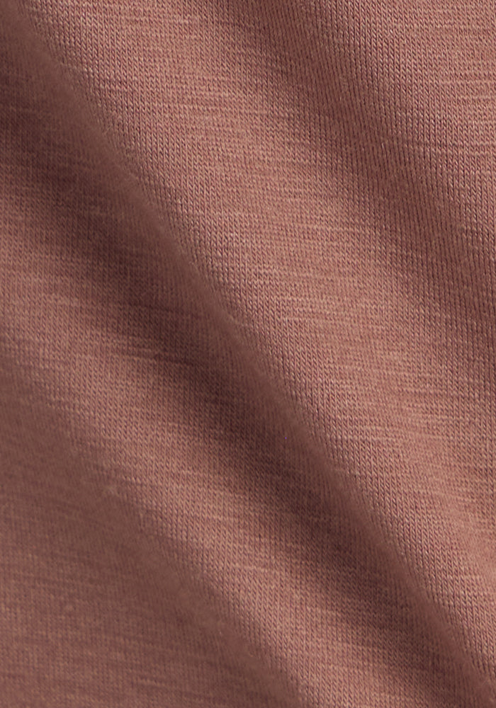 Close-up of soft, textured sienna fabric from the Woolx Bella Tunic Top with gentle folds and visible weave.