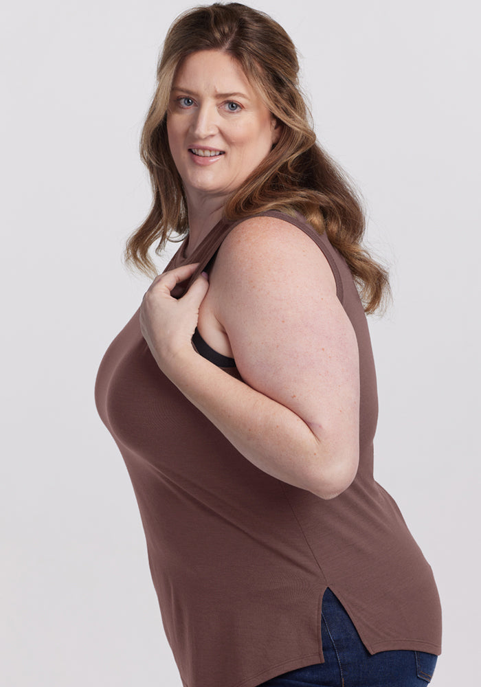 Woman with long brown hair smiles in a Woolx Bella Tunic Top - Peppercorn, posing against a plain background.
