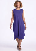 Woman in Woolx Cassie Dress - Berry Indigo and brown sandals, smiling, walking toward the camera on white background. | Tori is 5'7", wearing a size S