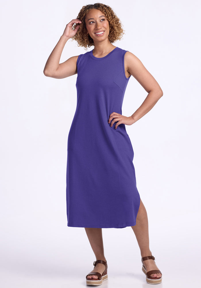 Woman wearing the Woolx Cassie Dress in Berry Indigo with brown sandals, smiling, hand on hip, white background.