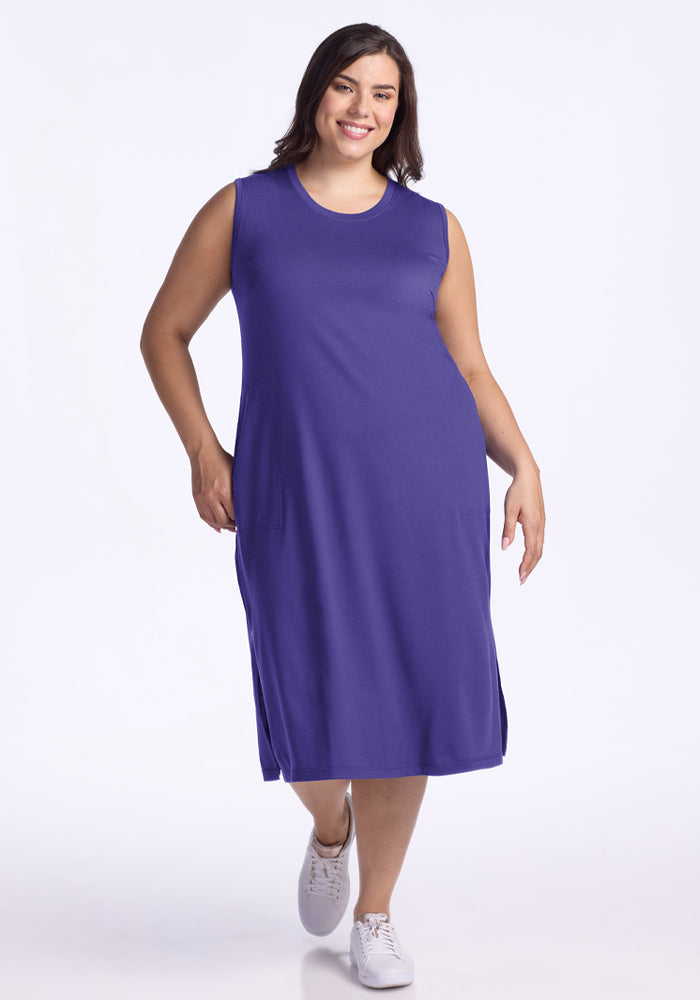 A woman in the Woolx Cassie Dress - Berry Indigo and white sneakers smiles against a plain white background. | Juliana is 5'10", wearing a size XL