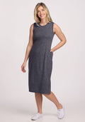 Smiling woman in Woolx Cassie Dress (Cinder Melange), final sale, and white sneakers, posing against a white background.