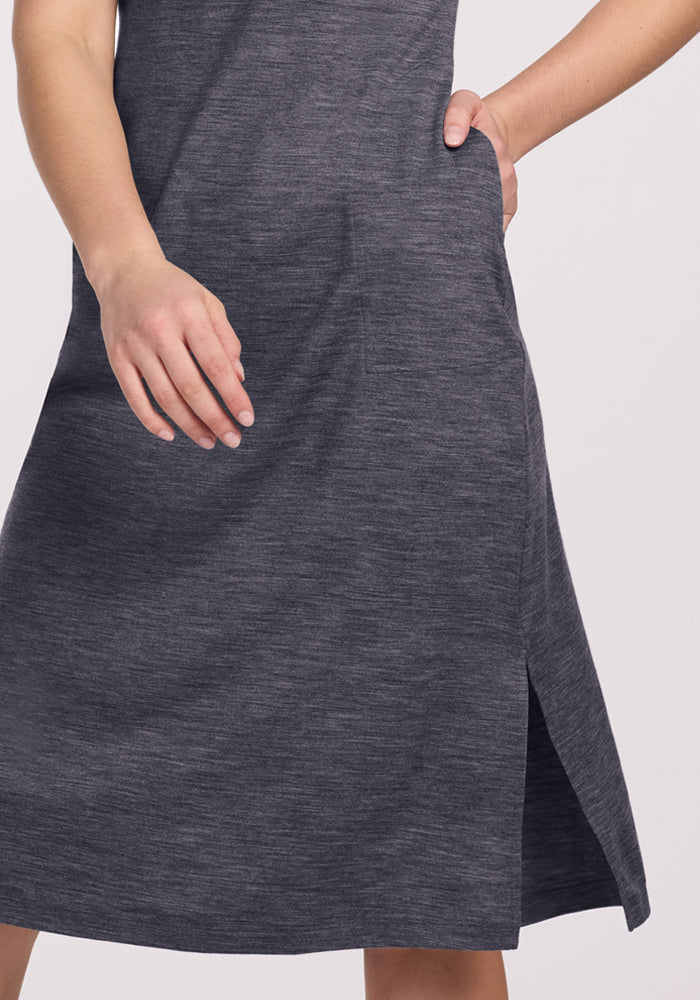 A person wearing the Woolx Cassie Dress in Cinder Melange, featuring a wrinkle-resistant fabric and side slit.