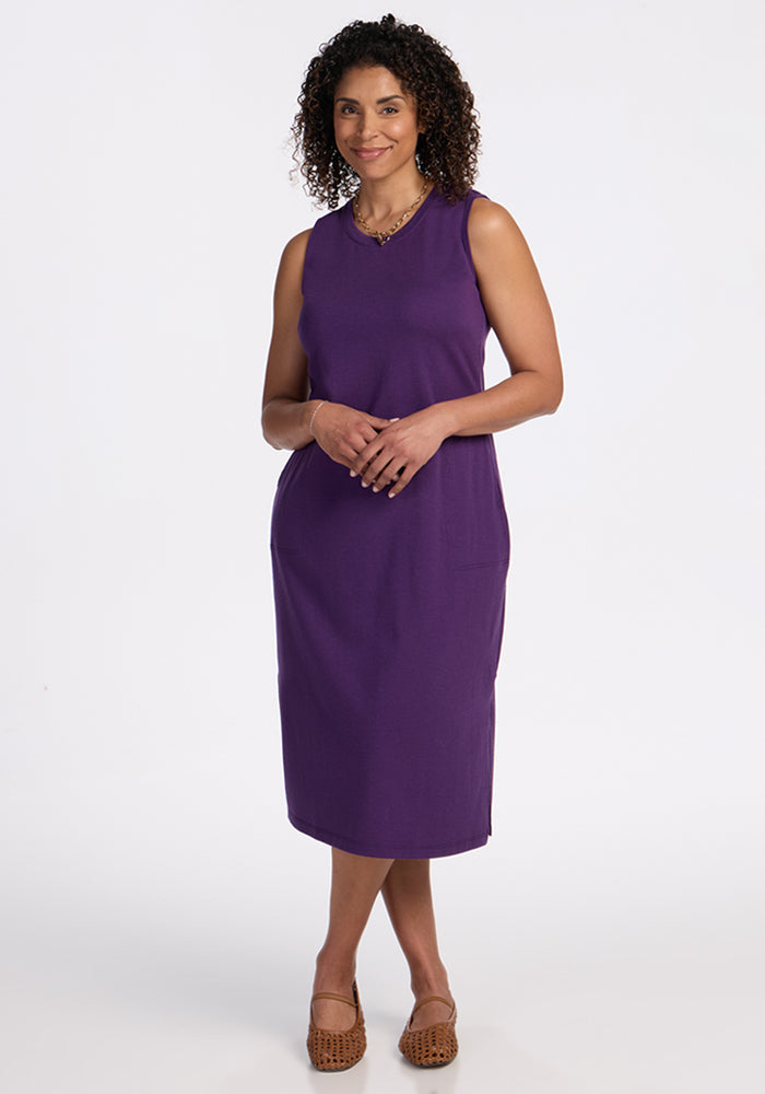 Woman in the Woolx Cassie Dress in Plum Crush, standing against a white background, wearing brown shoes.
