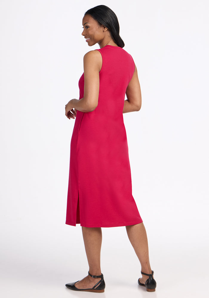Woman wearing the Woolx Cassie Dress in Poppy Spark, smiling and standing, facing away.