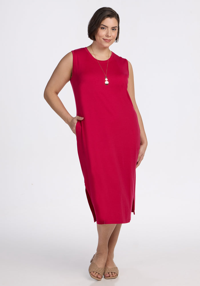 Woman in Woolx Cassie Dress • Final Sale - Poppy Spark, sleeveless with pockets, standing and smiling.