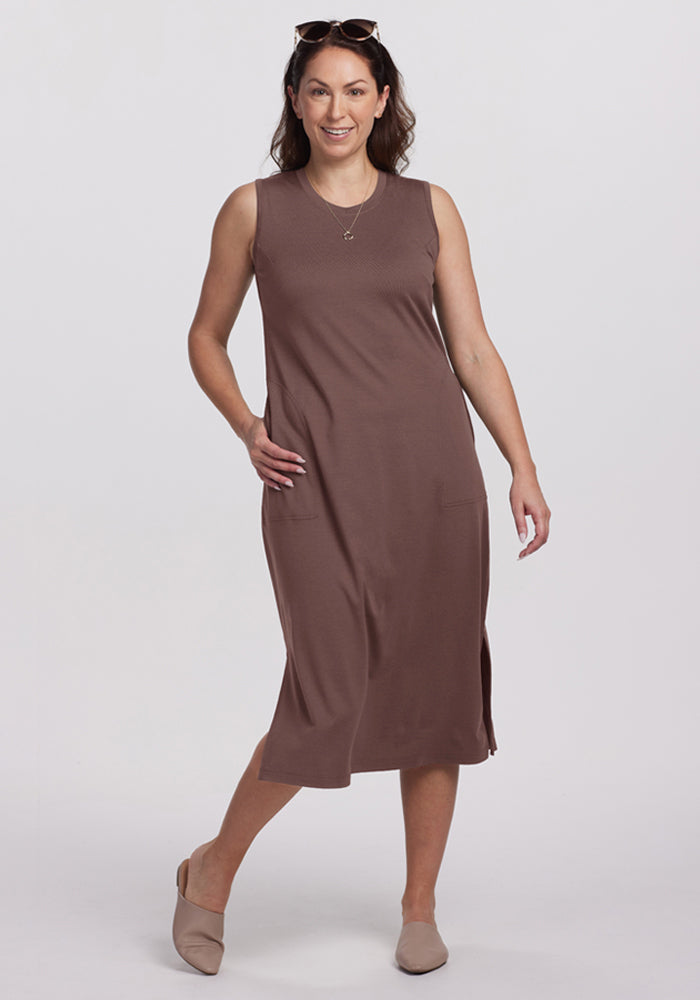 Woman wearing the Woolx Cassie Dress in Peppercorn, beige flats, and sunglasses on her head, smiling and posing. | Tiffany is 5’8”, wearing a size S