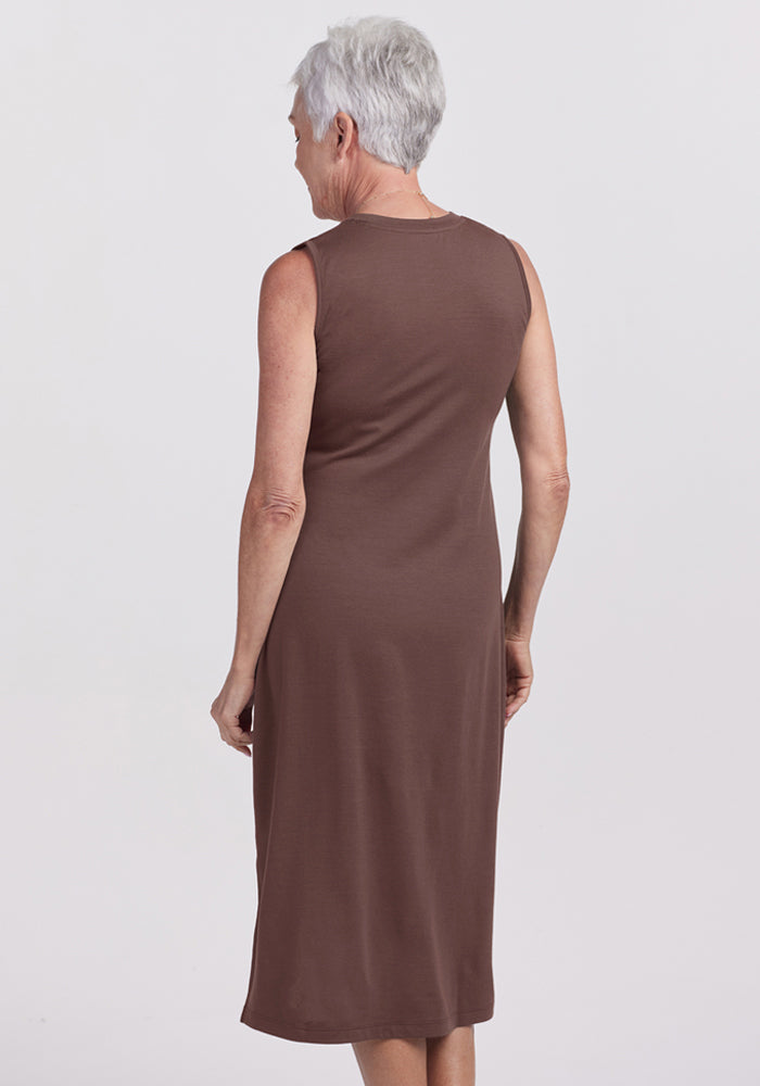 Older woman with short gray hair in the Woolx Cassie Dress - Peppercorn, seen from behind against a plain background.