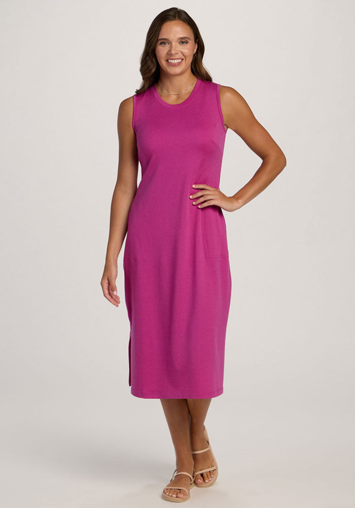 Woman in the Woolx Cassie Dress - Summer Sorbet, sleeveless and knee-length, smiling against a light background. | Madeleine is 5’10”, wearing a size XS