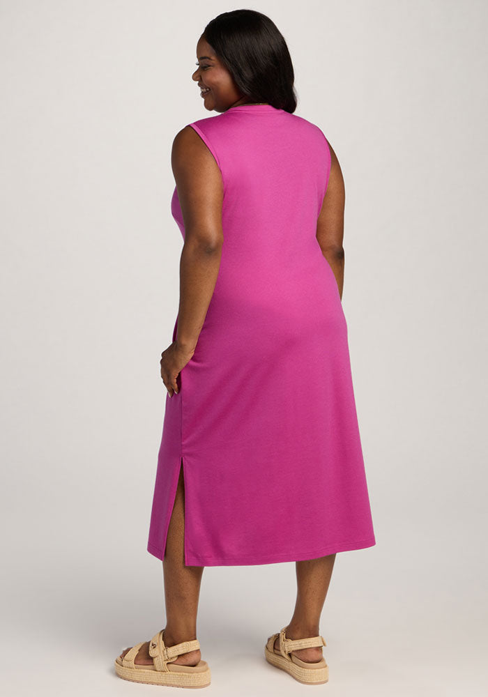 Woman in the Woolx Cassie Dress - Summer Sorbet, wrinkle-resistant with side slit, facing away in beige sandals.