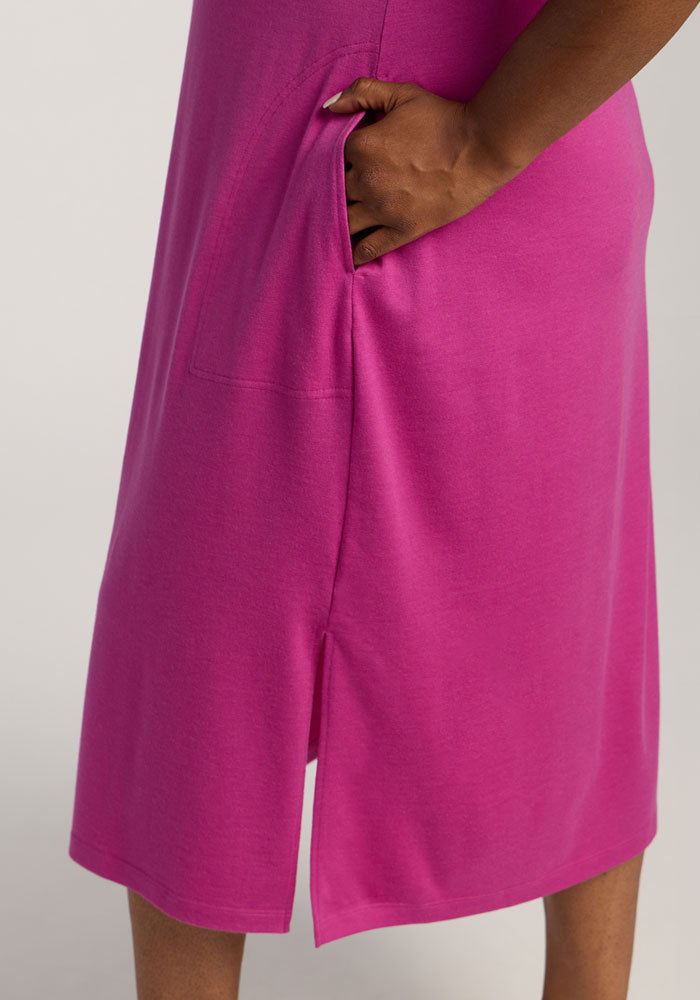 A person wears the Woolx Cassie Dress in Summer Sorbet, hand resting in its side pocket.