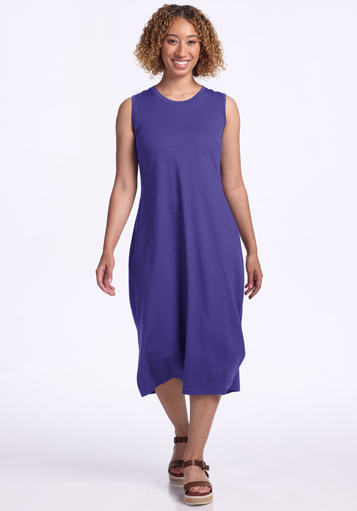 Woman in Woolx Cassie Dress - Berry Indigo and brown sandals, smiling, walking toward the camera on white background. | Tori is 5'7", wearing a size S