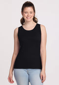 A woman with light skin and brown hair in a ponytail is smiling, wearing the Woolx Chessy Tank Top in black and light blue jeans, standing against a plain white background. | Lilly is 5’9”, wearing a size S