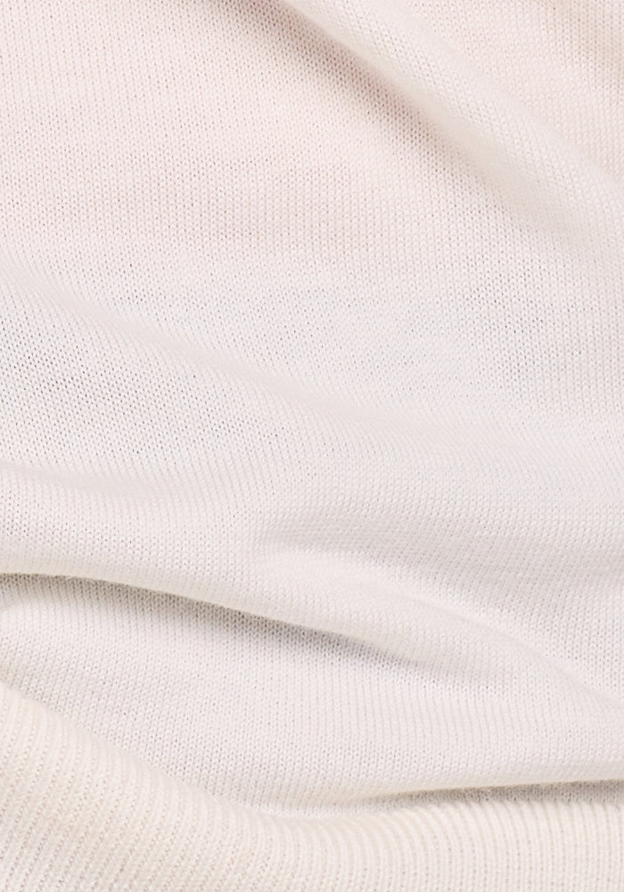 A close-up of the Dewdrop Pearl Chessy Tank Top by Woolx highlights its soft, textured fabric with a subtle ribbed pattern, showcasing natural folds and a smooth finish.