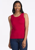 A woman with long dark hair smiles while wearing the Woolx Chessy Tank Top in Poppy Spark, paired with blue jeans and a gold necklace, standing against a plain white background. | Jade is 5’10”, wearing a size S