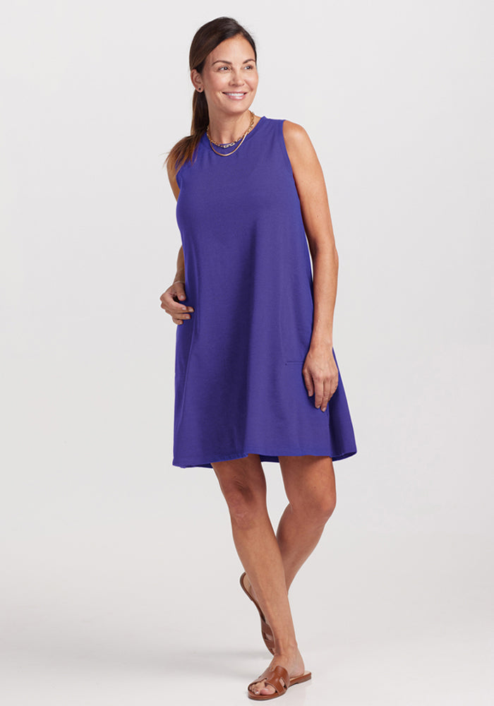 Woman wearing the Woolx Clara Dress - Berry Indigo, standing and smiling against a plain background. | Shannon is 5’8”, wearing a size S