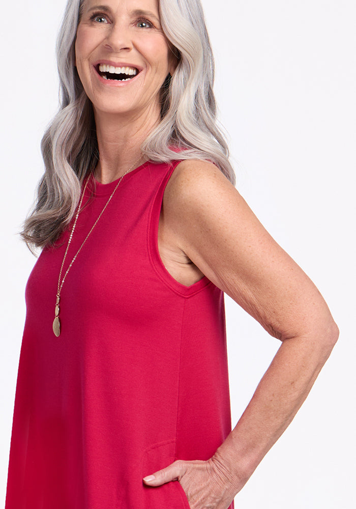 Smiling older woman in Woolx Clara Dress • Final Sale - Poppy Spark, gold necklace, long gray hair, hand in pocket.