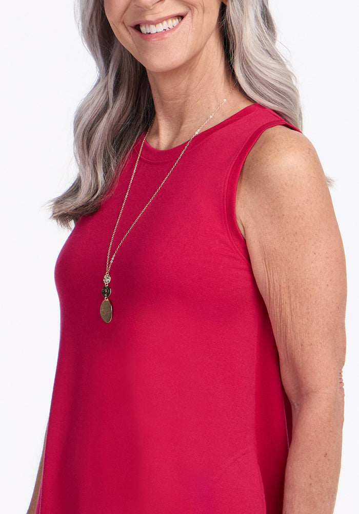 Smiling woman in the Woolx Clara Dress • Final Sale - Poppy Spark, shown from the shoulders up with a necklace.
