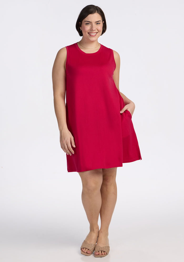 Woman in the Woolx Clara Dress • Final Sale - Poppy Spark stands smiling in tan sandals against a plain white background.