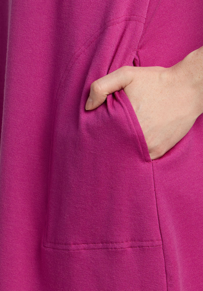 A hand is shown inside the pocket of the Woolx Clara Dress - Summer Sorbet.