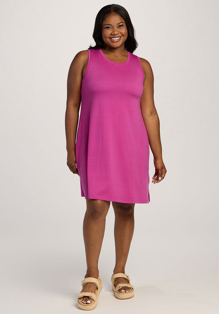 Woman in Woolx Clara Dress - Summer Sorbet, smiling in beige sandals against a plain white background. | Sapphire is 5’8”, wearing a size XL