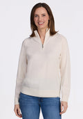 A woman with shoulder-length brown hair smiles while wearing the Woolx Collins Half Zip Sweater in Dewdrop Pearl and blue jeans, standing against a plain white background. | Jessica is 5’10”, wearing a size S