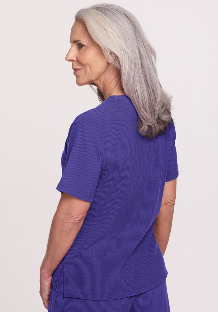 Older woman in Woolx Delia Ribbed Short Sleeve - Berry Indigo, facing sideways against a plain background.