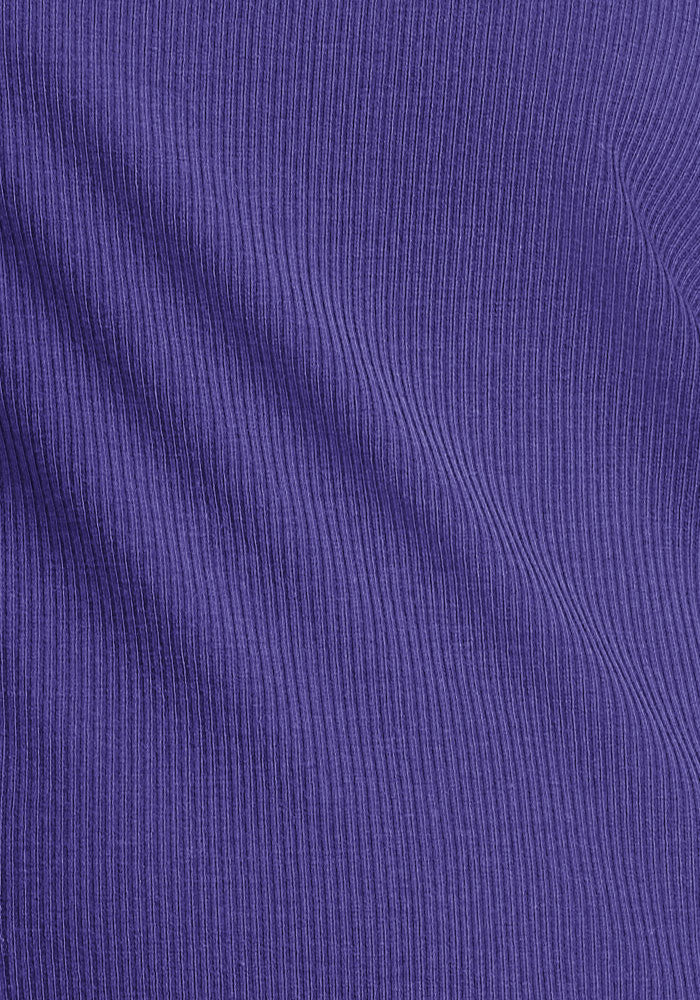 Close-up of ribbed fabric in Berry Indigo on the Woolx Delia Ribbed Short Sleeve, showing textured lines and soft folds.