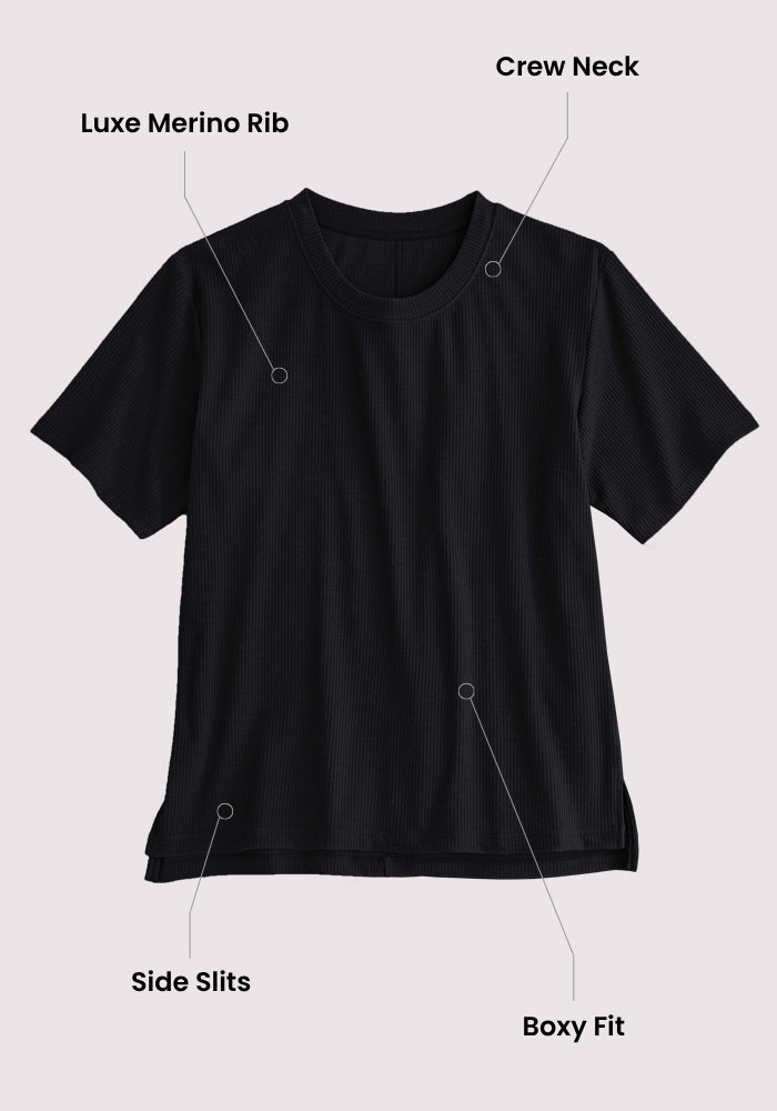 Woolx Delia Ribbed Short Sleeve - Black: a luxurious merino wool top with ribbed texture, crew neck, short sleeves, side slits, and loose fit. Displayed on a light background with labeled callouts for each feature.
