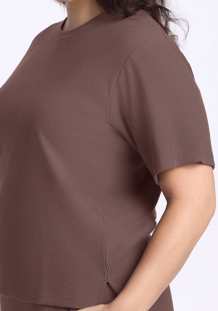 Woman wearing the Woolx Delia Ribbed Short Sleeve in Peppercorn, shown from shoulders to mid-torso on a plain background.