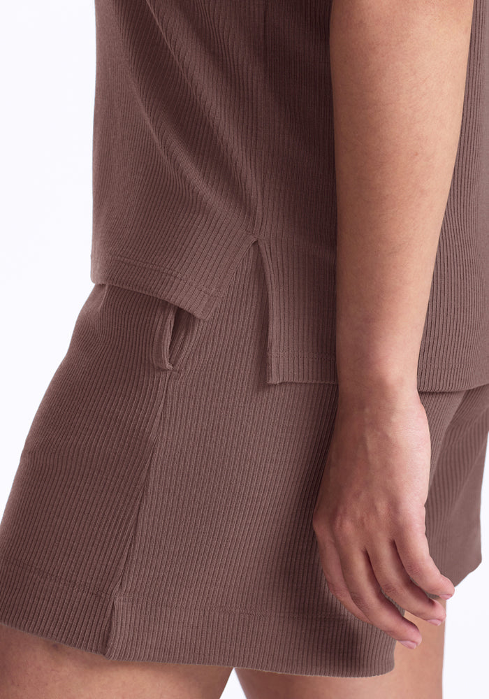 Person wearing the Woolx Delia Ribbed Short Sleeve in Peppercorn with matching shorts, shown from the side, arm relaxed.